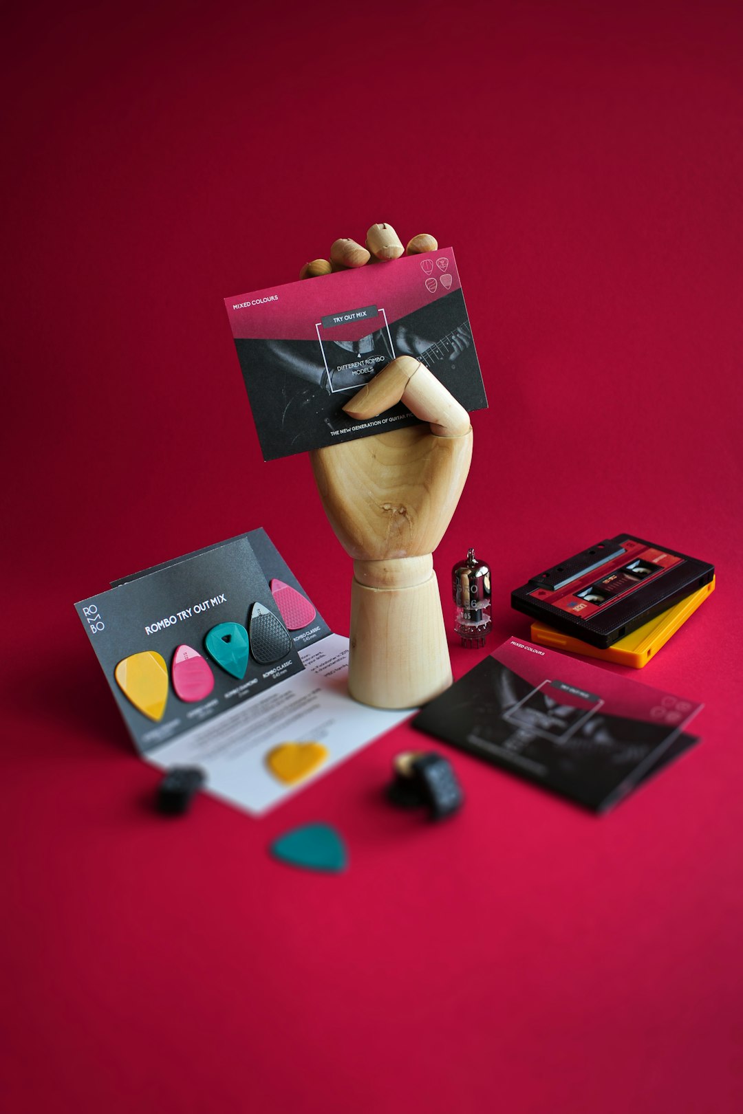 Guitar pick hold by wooden hand